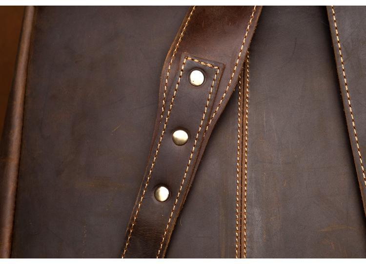 Brown leather backpack detail of stitched strap panel with snap buttons