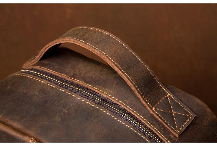 Brown leather backpack detail of top carry handle and double zipper