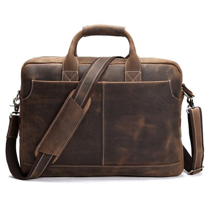 Vintage leather messenger bag in dark brown with top handle, front pockets, and crossbody strap