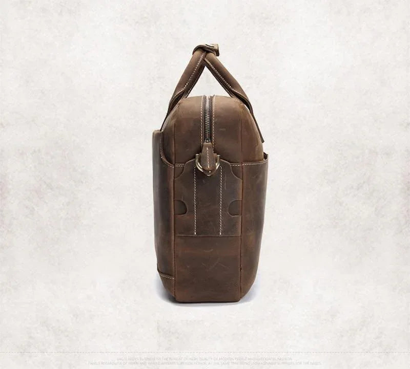 Vintage leather messenger bag in dark brown with top handle and vertical front zip pocket