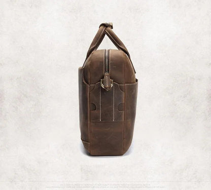 Vintage leather messenger bag in dark brown with top handle and vertical front zip pocket