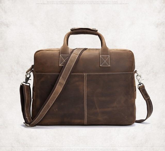 Vintage leather messenger bag in dark brown with top handle and adjustable shoulder strap