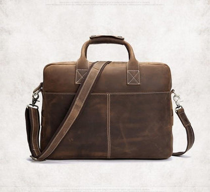 Vintage leather messenger bag in dark brown with top handle and adjustable shoulder strap