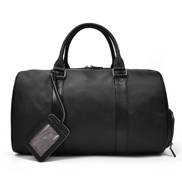 Black leather weekender duffle bag with top handles and hanging ID tag strap.