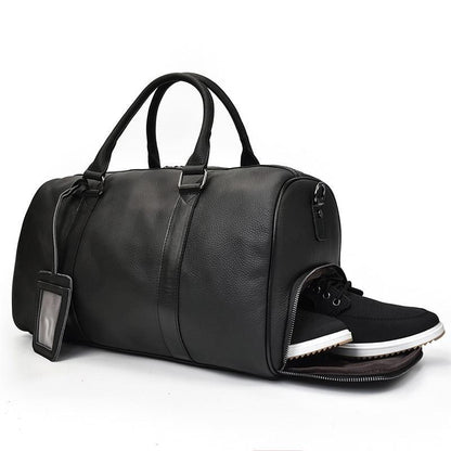 Black leather weekender duffle bag with side zipper and built-in shoe compartment.
