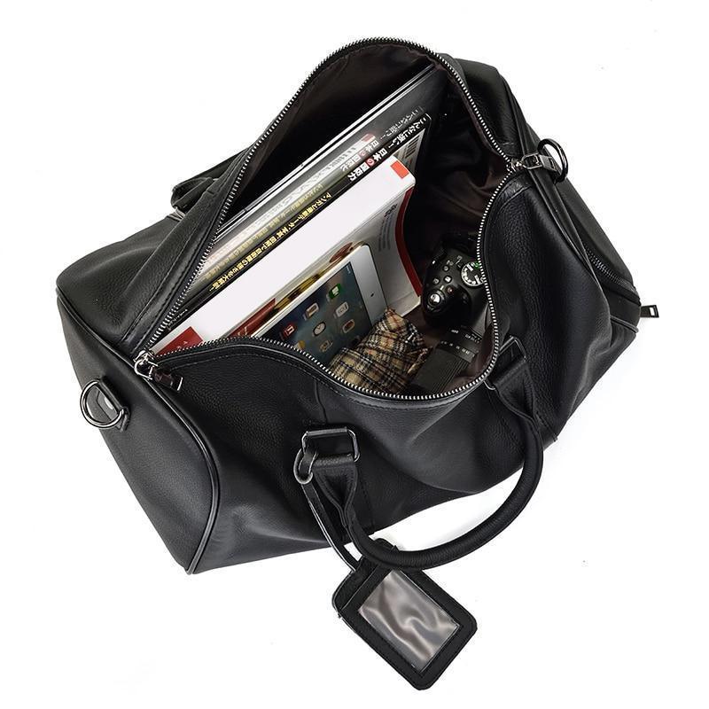 Black leather weekender duffle bag open with zip pocket and card-slot organizer inside.