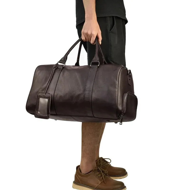 Brown vintage leather weekender duffle bag with two top handles and side zip details