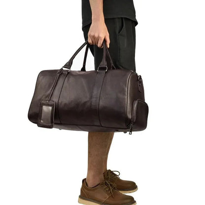 Brown vintage leather weekender duffle bag with two top handles and side zip details