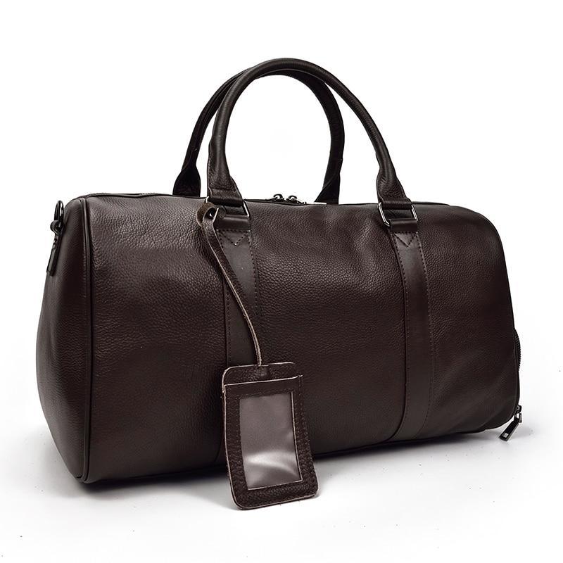 Brown vintage leather weekender duffle bag with top handles and hanging luggage tag