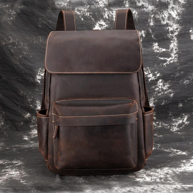 Vintage leather laptop backpack in dark brown, front flap and stitched middle pocket.