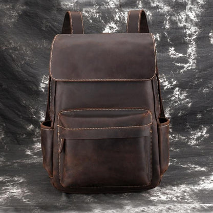 Vintage leather laptop backpack in dark brown, front flap and stitched middle pocket.