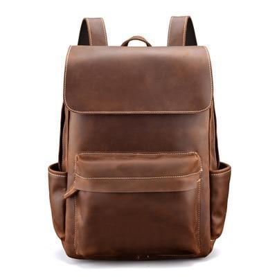 Vintage leather laptop backpack in brown, front flap with two compartments.