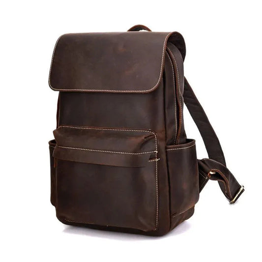 Vintage leather laptop backpack, side view with shoulder strap and front pocket.