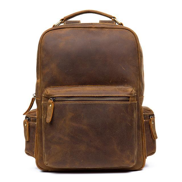 Brown vintage leather backpack with top handle, front zip pocket, and side zip details.