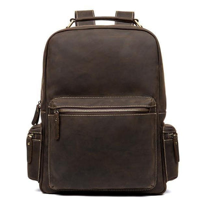 Dark brown vintage leather backpack with top handle, front zip pocket, and adjustable straps.