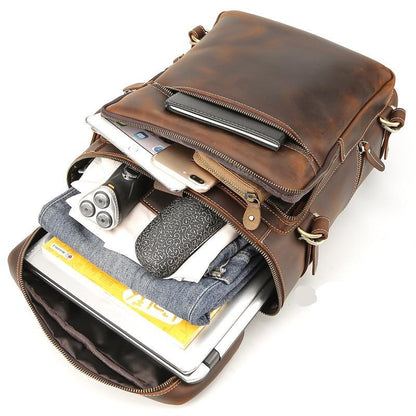 Vintage cow leather backpack open with inner organizer and visible zipper compartments