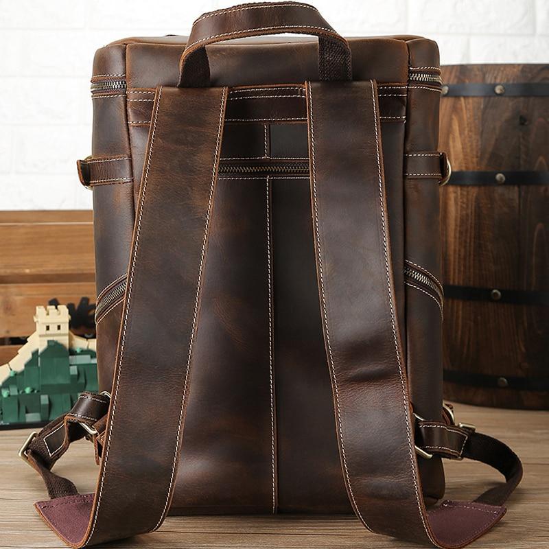 Vintage cow leather backpack, back view with vertical strap panels and side zipper pocket