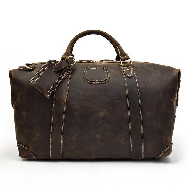 Vintage leather duffle bag in dark brown with top handles and side straps.