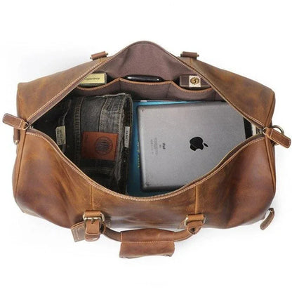 Brown leather duffle bag open inside showing organizers with card and device pockets.