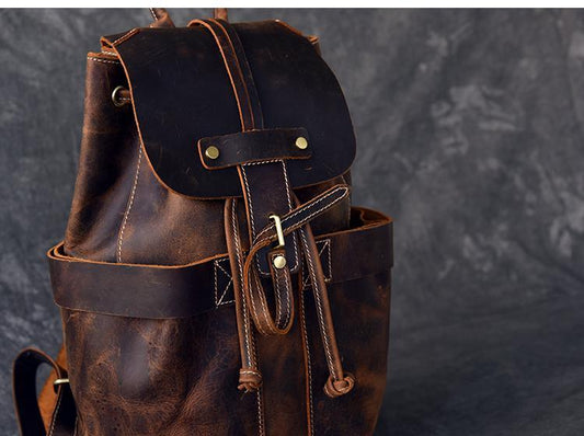 Brown leather rucksack with front flap pocket and adjustable shoulder straps