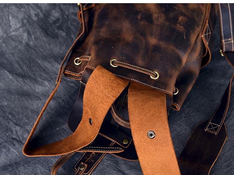 Leather rucksack with crossbody strap, belt loops, and reinforced metal grommets