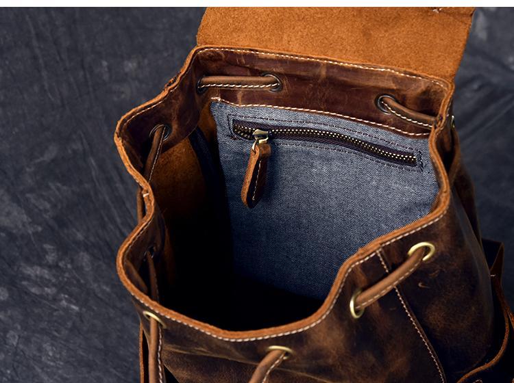 Leather rucksack top view with zip pocket and stitched lining inside opening