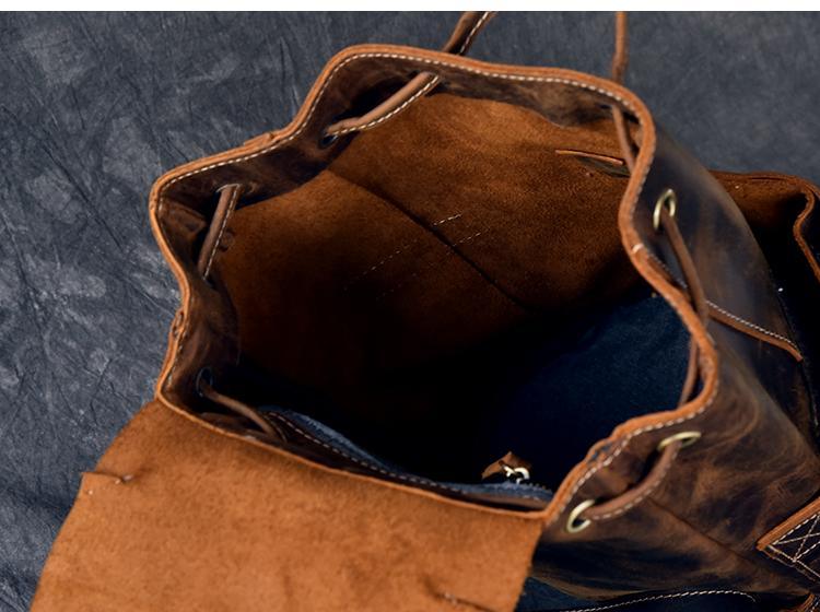 Vintage leather backpack interior with open top and side drawstring cords