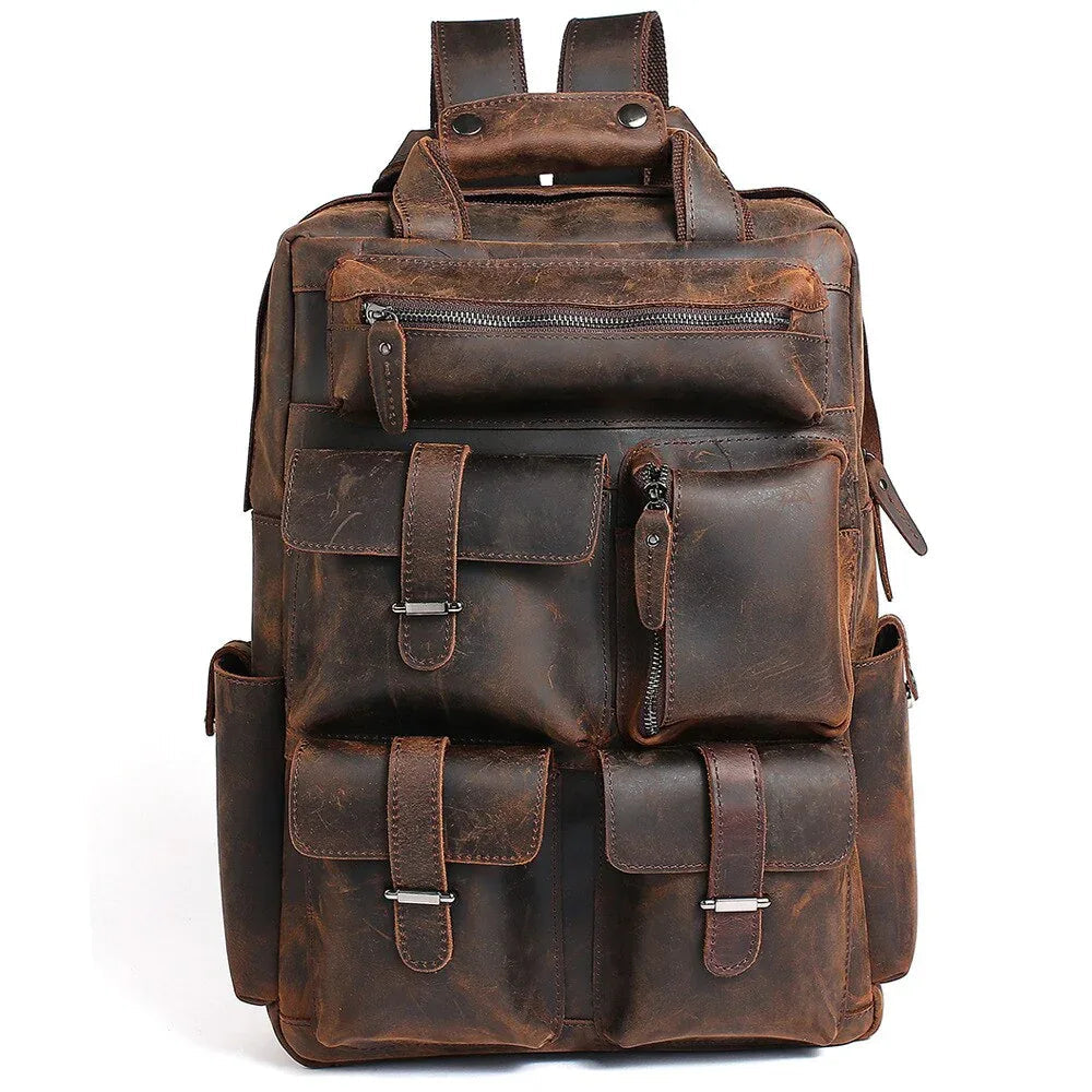 Brown handmade leather backpack with front pockets and buckle straps.