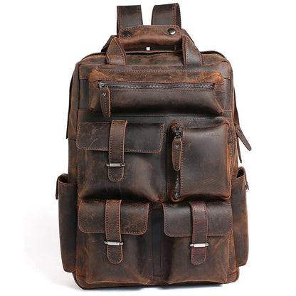 Brown handmade leather backpack with front pockets and buckle straps.