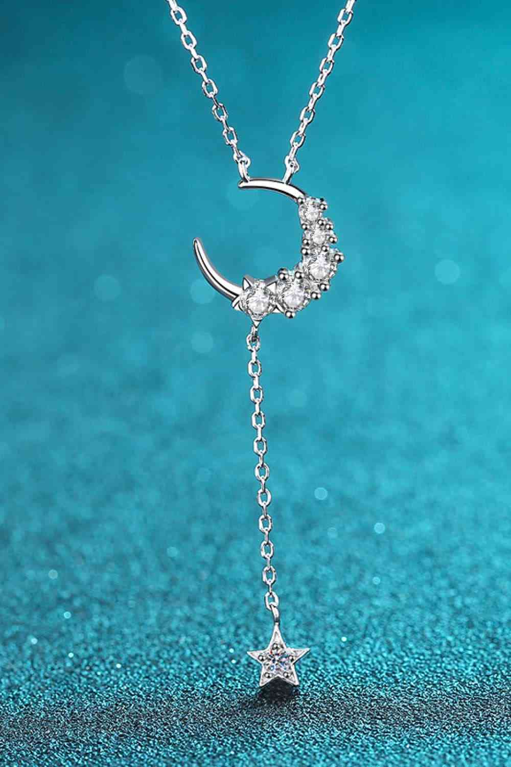 Star & Moon Moissanite Necklace with blue background
