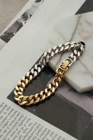 Steel and Gold Bracelet on a table