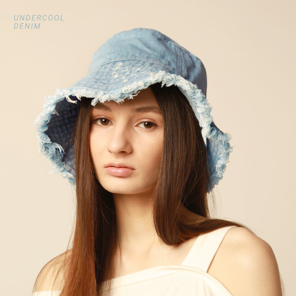 Model wearing the Plain Frayed Bucket Hat in undercool denim