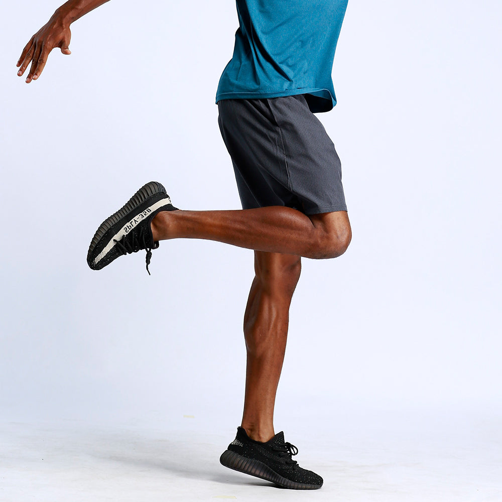 Men's Sports and Fitness Running Shorts action shot man stretching leg dark grey shorts