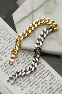 Steel and Gold Bracelet over a book