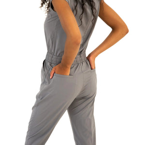Plain Grey Jumpsuit model with hands in the butt pockets