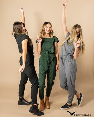 Collection of models standing up wearing the jumpsuit in black green and grey