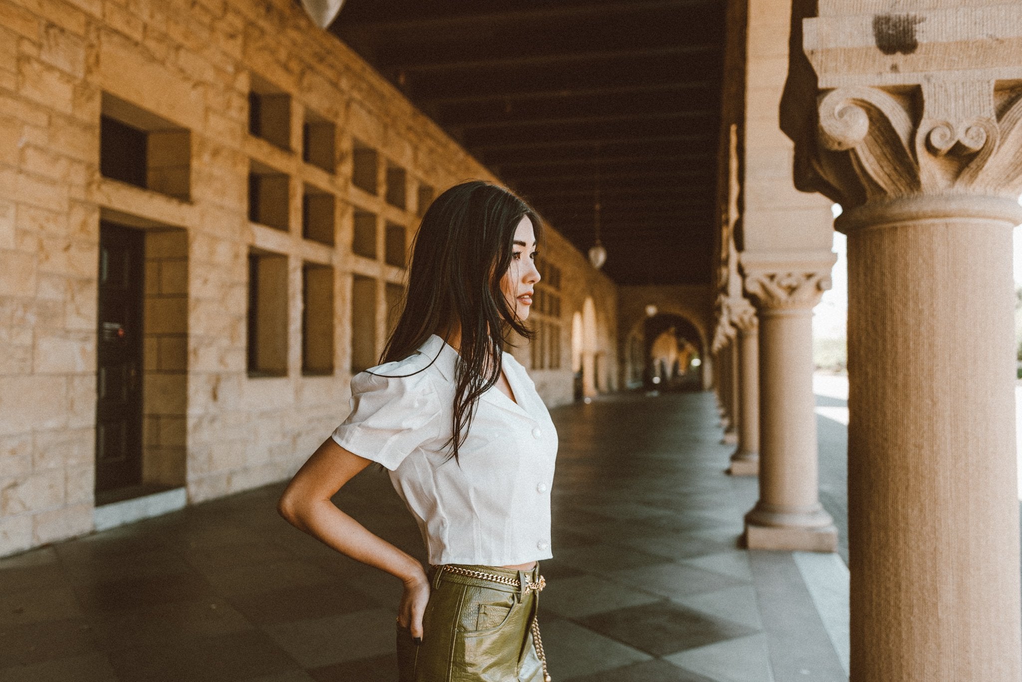 Picture of a Women's White Puffed Sleeve Button-Down Blouse side view woman standing in a historic building